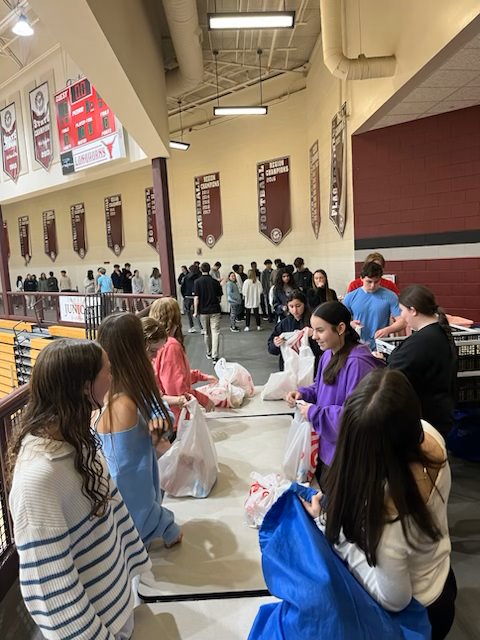 Students at Lambert High School in Suwanee, GA, gather every week to fill backpacks with food for students throughout their county as part of the Blessings in a Backpack program. Photo courtesy of Ed Gray.