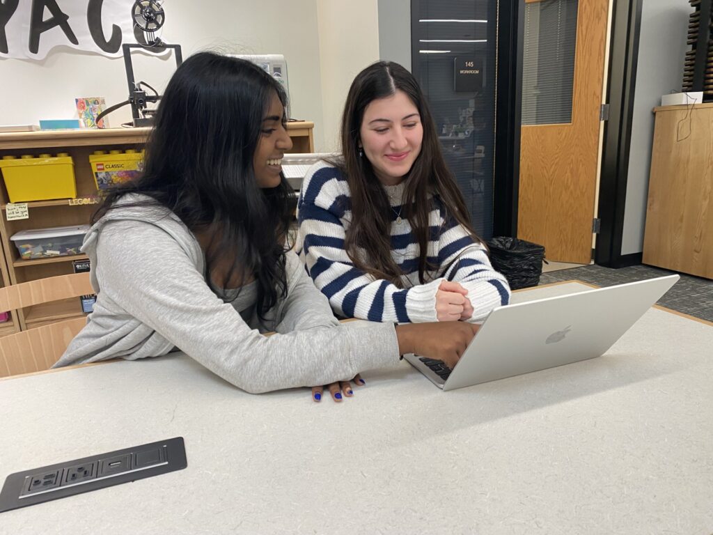 Amy Cherian, left, NHS president at Freedom High School, tutors a student.